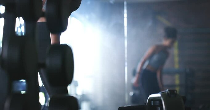Fitness woman, walking and rowing machine at gym for training, health or wellness routine. Sports, workout and athlete with pulling exercise, energy or mindset, resilience or weight loss motivation