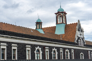 Fototapeta premium Gothic splendor of Dunedin's cathedral and its historic train station, iconic landmarks on New Zealand's South Island. Perfect for architecture enthusiasts, urban explorers, and history Victorian 