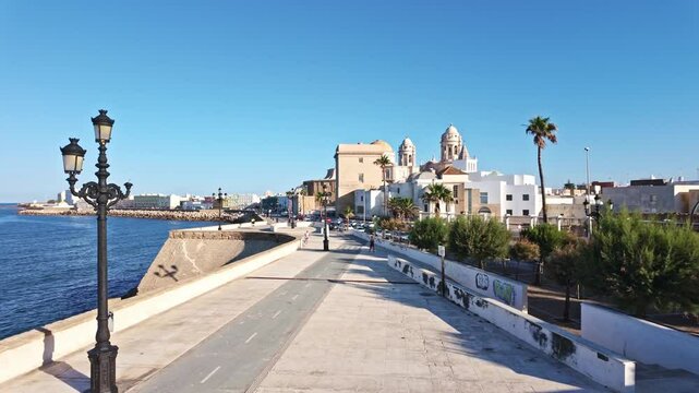 Promenade and Atlantic Ocean with Cadiz Cathedral in the background, Andalusia, Spain