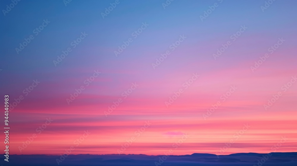 Poster A stunning gradient of sunset colors spreads across the sky, with deep reds and soft pinks blending seamlessly into the twilight blue.