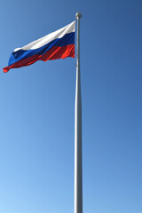 Flag of Russian Federation on background of blue  sky