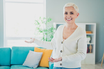 Photo of charming adorable cheerful woman showing own new cozy home apartment real estate agency credit