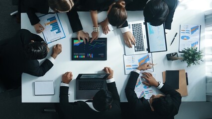 Top view of smart business people brainstorm marketing idea at meeting table while compare stock market investment data between laptop and tablet. Business team planning financial plan. Directorate.