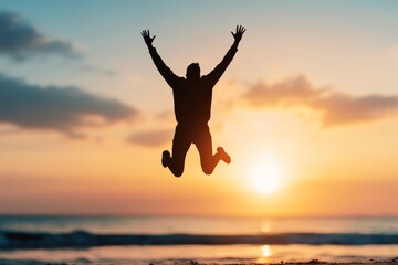 Silhouetted Joyful Man Jumping Against Sunset on Beach Horizon