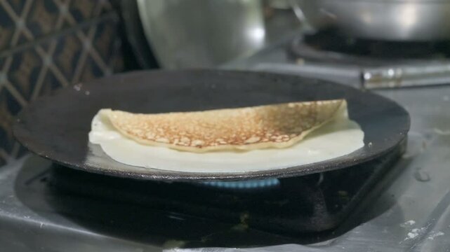 Home made preparation of Patishapta Pitha, a famous Bengali Dessert Recipe, during Winter season. Patishapta is a type of pithe made in celebratory occasions, quick Indian dessert. West Bengal, India