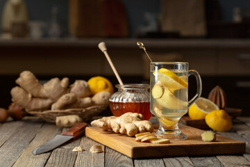 Ginger tea with lemon and honey on an old wooden table.