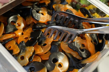 halloween orange and black gummy jelly skull candies candy shop plastic container. Trick or treat
