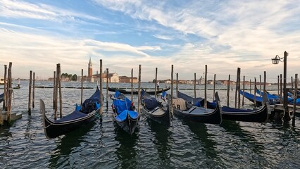 A group of boats are docked in the water, with some of them being blue