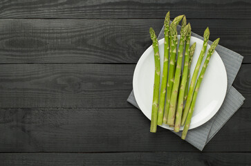 Fresh asparagus on wooden background, top view