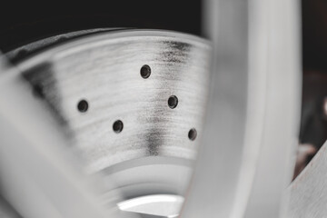 Closeup of Automotive Drilled Disc Brake Rotor in Workshop