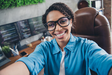 Photo of lovely young lady selfie photo cheerful smile coding dressed blue shirt comfortable programmer startup office loft room interior