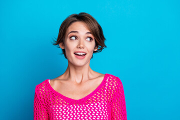 Photo of funky dreamy lady dressed knitted pink shirt looking empty space isolated blue color background