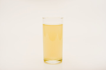A glass glass with soda on a white background. Juice in a glass.