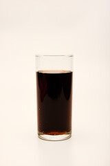 A glass glass with soda on a white background. Juice in a glass.