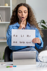 Cute long-haired speech therapist conducting an online tutorial