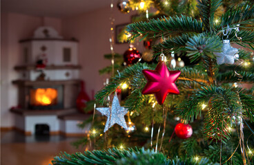 Christmas and New Years background with fir tree and blur burning fireplace .