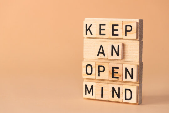 Keep open mind symbol. Wooden blocks with words Keep open mind arranged by businessman hand. Beautiful background. Business concept words Keep open mind. Copy space.