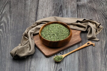 Dry mint in wooden spoon isolated on wooden background