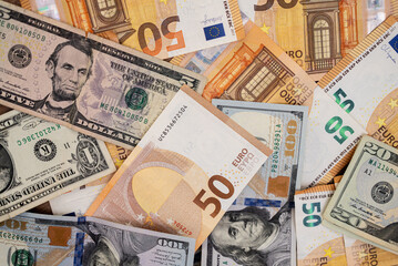 Assortment of Euro and US Dollar banknotes in various denominations. International finance and currency exchange concept 