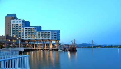 Obraz premium Hotel on the riverside, promenade, restaurant and cruise paddle wheeler