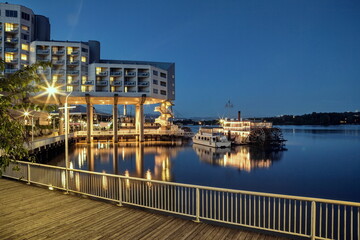 Hotel near the river evening illumination, paddle wheeler and restaurant at the waterfront of New Westminster City