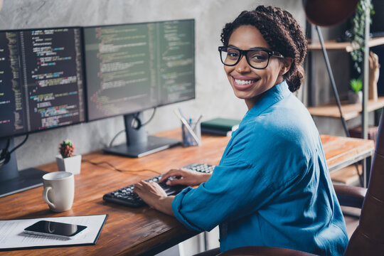 Photo of attractive young woman working monitor coding wear blue shirt modern office programmer loft room interior indoors workspace
