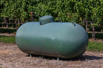 A propane or LPG tank in a farmer's field for frost control