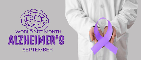 Male urologist with blue ribbon on light background, closeup. Prostate cancer awareness concept