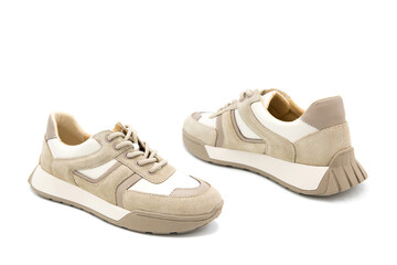 Sneakers. Pair of fashionable leather with suede inserts shoes isolated on white background.	