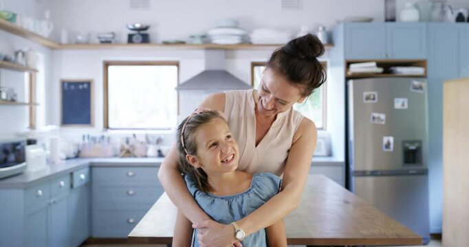 Mom, girl child and kitchen with face together, smile and hug with bonding, care and excited with laugh in house. Love, mother and daughter with comic joke, funny portrait and happy in family home