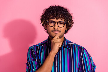 Photo of nice young man hand touch chin ponder wear shirt isolated on pink color background