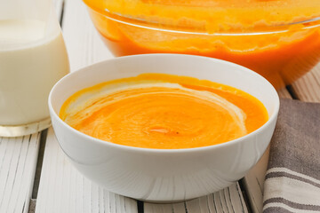 Roasted butternut squash soup served with a crispy bacon and heavy cream topping