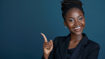 Professional African woman pointing with a bright smile