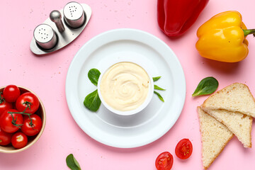 Plate with box of processed cheese, toasts and vegetables on pink background