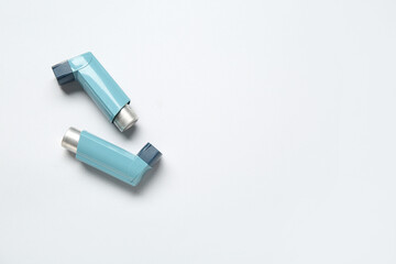 Asthma inhalers on grey background