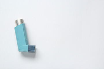 Asthma inhaler on grey background