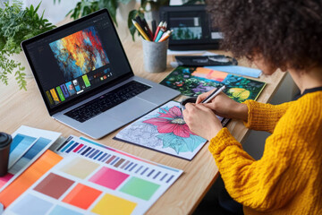 Female graphic designer with tablet and coffee working at table in office, top view