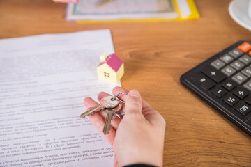 Real estate agent handed over the key to new home, marking a successful investment in business of...
