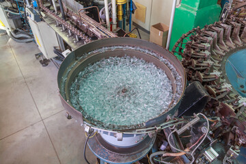 Conveyor line of big factory with light bulbs.