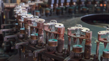 Conveyor line of big factory with light bulbs.
