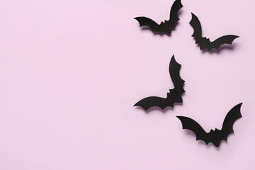 Paper bats for Halloween party on lilac background