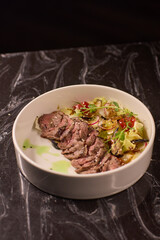 Indulge in Deliciously Tender Sliced Beef Accompanied by a Medley of Fresh Vegetables