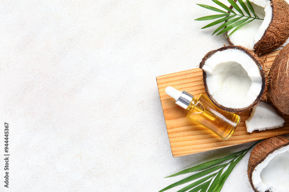 Wall mural wooden board with bottle of coconut cosmetic oil and plant leaves on white background