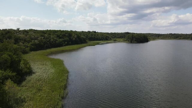 Fly over green nature and lake at the K&ouml;lpingsee area which is close located to Jabel