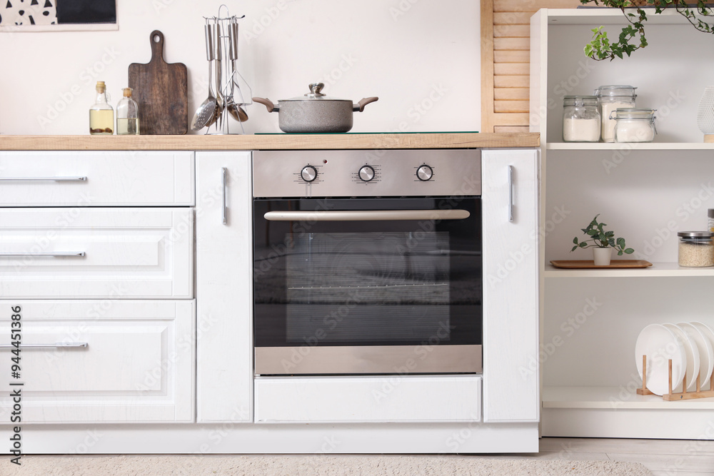 Wall mural Interior of kitchen with white counters and oven