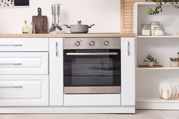 Interior of kitchen with white counters and oven