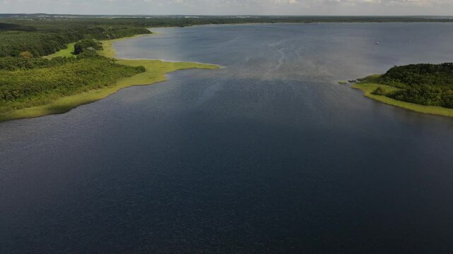 Fly over green nature and lake at the K&ouml;lpingsee area which is close located to Jabel