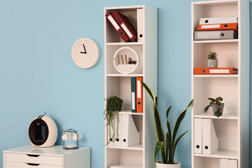Shelf units with document folders and plants in office