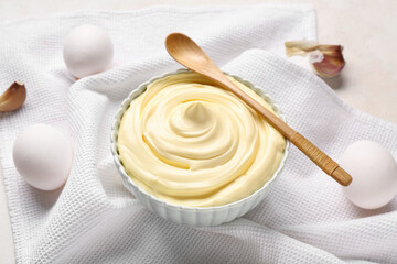Bowl of fresh mayonnaise on white background
