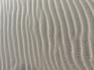 Beach sand wave pattern created by wind and waves